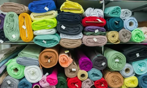 Fabric rolls stored on racks for selection and costing.